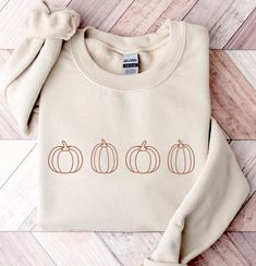 CHRISTMAS DEADLINE: We can no longer guarantee shipment by Christmas. Sorry :(  These unisex cozy sweatshirts (we use Gildan) are embroidered with outlines of pumpkins🍁 * 50% cotton, 50% polyester * Pre-shrunk * Classic fit * 1x1 athletic rib knit collar with spandex * Air-jet spun yarn with a soft feel and reduced pilling * Double-needle stitched collar, shoulders, armholes, cuffs, and hem SIZING: Please ensure you check measurement chart before ordering as shirts are printed once you place yo Cute Sweaters For Fall, Fall Sweatshirt, Cozy Sweatshirts, Fall Sweaters, Pumpkin Patch, Rib Knit, Sweatshirts Hoodie, Cute Outfits, Adult Outfits