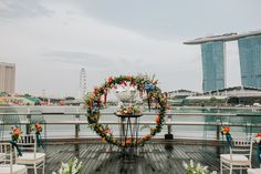 an outdoor ceremony setup with flowers and greenery on the deck of a cruise ship