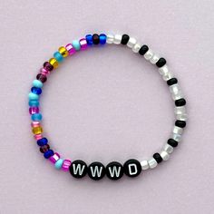 "WWWD (What Would Wednesday Do) bracelet! Handmade with love using Czech glass beads, black and white letter beads and stretch cord. Get creative! All my bracelets are meant to be mixed, matched & stacked!  SIZING: Measure your wrist around the widest point and add .25-.5 inches to get the most comfortable or desired fit. If you don't have a flexible tape measure, you can use a piece of string to wrap around your wrist and then measure the length of the string. (For example: my wrist size is 6\" and I will wear a 6.5\" bracelet for a snug fit and 7\" for a loose fit). CARE INSTRUCTIONS: Please be careful to not overstretch bracelets too far. They are made out of a durable elastic string but are still capable of breaking if not handled carefully. Avoid submerging bracelets in water and stor Trendy Black Name Bracelet With Round Beads, Black Letter Beads Friendship Bracelets, Trendy Black Name Bracelet With Letter Beads, Casual Black Friendship Bracelets With Letter Beads, Trendy Black Beaded Bracelets With Letter Beads, Casual Black Stretch Bracelet With Letter Beads, Trendy Black Bracelets With Letter Beads, Black Friendship Bracelets With Colorful Beads For Everyday, Black Friendship Bracelets With Colorful Beads