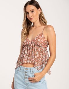 Full Tilt Hanky Mesh Cami. Allover Floral Print On Mesh Fabric. V-Neckline And Tie At Center Chest. Adjustable Spaghetti Straps. Hanky Hem. 95% Polyester, 5% Spandex. Lining: 100% Polyester. Hand Wash. Imported. Model Is Wearing A Size Medium. Model Measurements:height: 5'8" Bust: 32"waist: 23"hips: 34" Flirty V-neck Top For Spring, Flirty V-neck Spring Tops, Flirty Cami Top For Vacation, Flirty V-neck Tank Top For Summer, Casual Flowy Spaghetti Strap Top, Spring V-neck Camisole Casual Style, Spring V-neck Camisole In Casual Style, Casual V-neck Camisole For Spring, Spring Casual V-neck Camisole