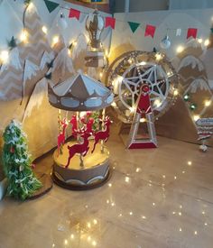 a merry christmas carousel with lights and decorations on the ground in front of a wall