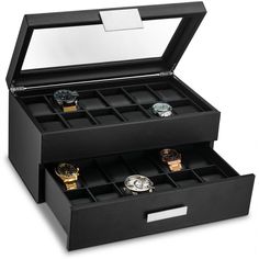 an open black watch box with four watches in it's compartments and the lid opened