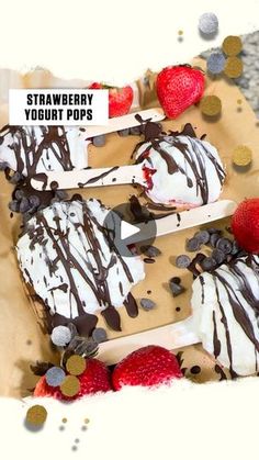 strawberries and ice cream are on sticks with chocolate drizzled over them