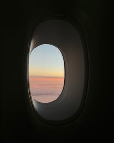 an airplane window looking out at the sky