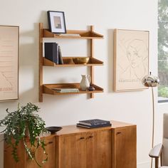 a living room filled with furniture and art on the wall next to a large window