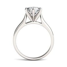 a white gold engagement ring with a round cut diamond in the center, on a white background