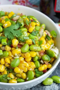 a white bowl filled with corn and cilantro