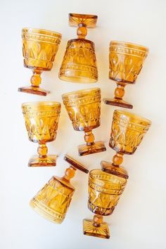 a group of yellow glass cups sitting next to each other