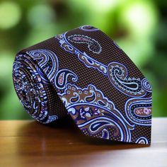 A Timeless Accessory: Shades of Brown, Light Blue, and Pink Paisley Silk Necktie Add a touch of sophistication to your wardrobe with this exquisite silk necktie featuring a harmonious blend of shades of brown, light blue, and pink in a classic paisley pattern. Available in both traditional width (3.25 inches) and a modern, slim design (2.5 inches), this versatile tie comes in regular (60 inches) and extra-long (63 inches) lengths. You can purchase it with a matching pocket square, an accenting d Luxury Tie For Gift, Luxury Standard Tie For Gift, Luxury Gift Tie, Classic Neckwear Standard Tie For Gift, Elegant Multicolor Ties As A Gift, Elegant Paisley Print Tie As A Gift, Elegant Paisley Print Ties As Gift, Elegant Patterned Neckwear With Ties, Classic Silk Ties As Gift