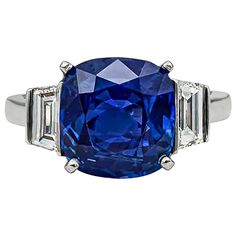 A gorgeous engagement ring, featuring a very rare 4.99 carats cushion cut blue sapphire certified by both AGL and Gubelin as Sri Lankan origin (Ceylon). Flanked by step-cut trapezoid diamonds weighing 1.02 carats total. Made with a platinum band. Size 5 US, resizable upon request.  Created and signed by Cartier. Comes with the original Cartier box, papers, bag, pouch, and jewelry cleaning kit.  Sapphires from Ceylon are some of the most beautiful, rare, and sought after sapphires in the world. Emerald Cut Solitaire Ring, Sapphire Antique Ring, Radiant Cut Diamond Ring, Kashmir Sapphire, White Gold Set, Gorgeous Engagement Ring, Blue Sapphire Diamond, Three Stone Engagement, Expensive Jewelry