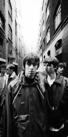 black and white photograph of young men walking down an alleyway