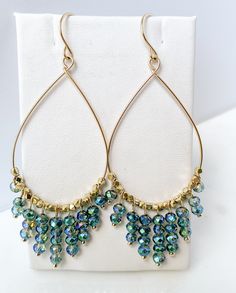 Are you looking for a unique and beautifully handcrafted accessory? Look no further than these handmade Gold Beaded Teardrop Hoop Earrings! As a single artisan handmade business based in California, I take pride in creating each pair of earrings with the utmost care and attention to detail.  Measuring approximately 3 inches long (including ear wire) and 1.25 inches wide, each hoop is beaded with multifaceted cut beads on 14k gold-filled wire.  Each ear wire is also handmade of 14k gold-filled.  The 14k gold-filled is manufactured in the USA.  Gold-filled is of higher quality and will last for years without tarnishing. I believe in the quality of my work, which is why I offer a Happiness Guarantee. If for any reason you're not completely satisfied with your purchase, you can return it withi Teardrop Hoop Earrings, Stained Glass Earrings, Blueish Green, Hoop Earrings Handmade, Jewelry Making Classes, Statement Hoop Earrings, Artisan Gift, Handcrafted Accessories, Earrings Inspiration