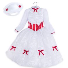 a white dress and hat with red bows