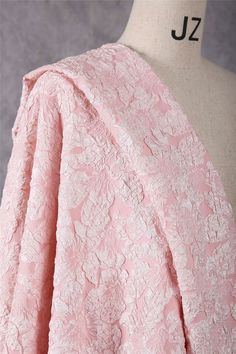 the back of a pink lace dress on a mannequin headdress,