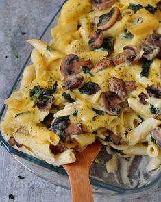 a casserole dish with mushrooms, spinach and cheese