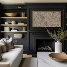 a living room filled with furniture and a fire place next to a wall mounted tv