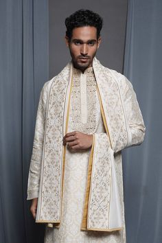 Ecru chanderi stole with floral embroidered border.
Pattern: Embroidered
Type Of Work: Floral
Fabric: Chanderi
Color: Cream
Other Details: 
Note: Pant and kurta worn by the model is not for sale
 - Aza Fashions Unstitched Tussar Silk Sherwani For Wedding, Traditional Tussar Silk Sherwani For Wedding, Traditional Drape Tussar Silk Sherwani For Wedding, Cream Raw Silk Traditional Wear For Ceremonies, Off White Raw Silk Traditional Wear For Ceremonies, Ceremonial Silk Sherwani With Dupatta, Wedding Sherwani With Resham Embroidery In Tussar Silk, Beige Raw Silk Traditional Wear For Ceremonies, Silk Sherwani With Dupatta For Ceremonial Occasions