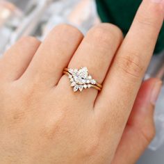 a woman's hand with a diamond ring on her finger and an engagement band