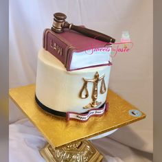 a cake that is sitting on top of a gold plate with a judge's book