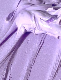 an animal's head is shown in this close up photo, with purple paint on the wall