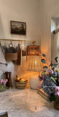 a kitchen counter with flowers and baskets on it