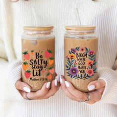 two women holding coffee mugs with strawberries on the top and saying, be salty stay