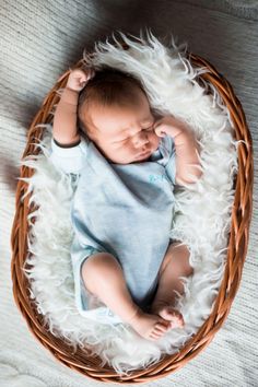 a newborn baby is laying in a basket