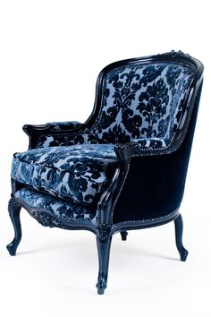 an ornate blue and black chair against a white background