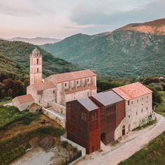 an aerial view of a church in the mountains