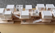 an aerial view of a model of a house with multiple floors and windows on top of a cardboard box