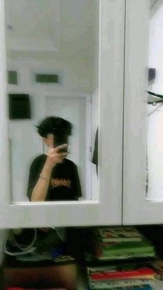 a person taking a selfie in front of a mirror