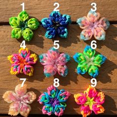 several different colored hair clips on top of a wooden table with numbers in the middle