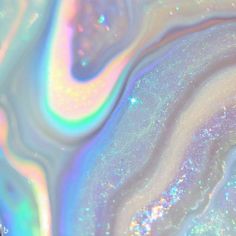 an abstract background with blue, green and pink colors in the center is swirling liquid