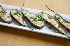 an appetizer plate with stuffed eggplant on it