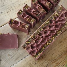 several pieces of chocolate sitting on top of a wooden table