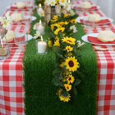 the table is set with sunflowers and greenery for a long dinner party