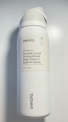 a white bottle with the words owala written on it is sitting against a wall