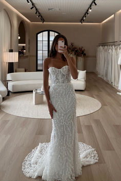 a woman taking a selfie in her wedding dress