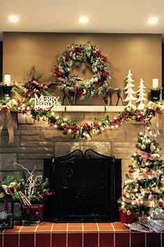 a fireplace decorated for christmas with wreaths and lights