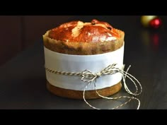 a loaf of bread wrapped in burlock and tied with twine on a table