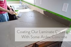 a man standing next to a counter in a kitchen under construction with the words coating our laminate counters with some apex concrete