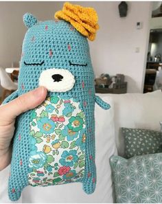 a crocheted stuffed animal is being held up to the camera