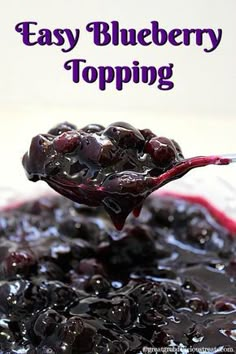 a spoon full of blueberry topping with the words easy blueberry topping