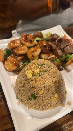 a white plate topped with rice and veggies