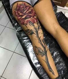 a woman with a rose tattoo on her leg