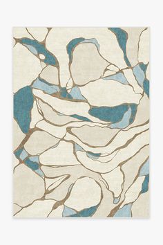 a white and blue rug with an abstract design on the bottom, in shades of beige and teal