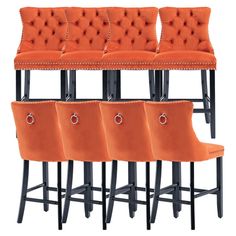 four orange velvet bar stools with buttons and studding on the backrests