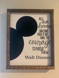 a framed mickey mouse quote on the wall