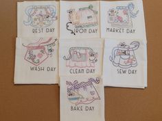 four embroidered tea towels with the words best day, crochet day, wash day, and bake day