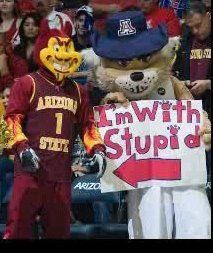 the mascot is holding a sign in his hand